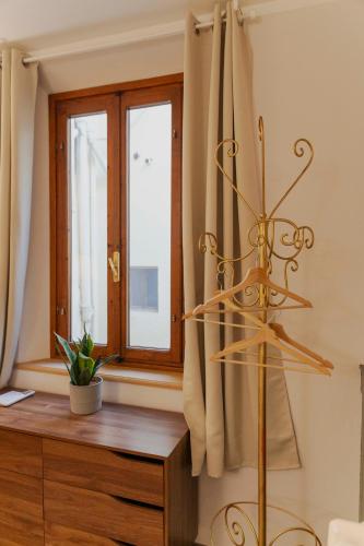 a room with a window and a wooden dresser at Affittacamere Zanobi 45 in Florence