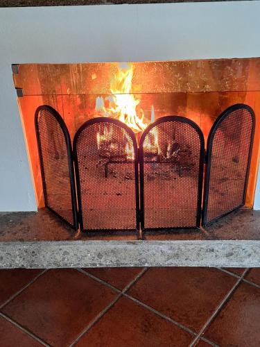 a fireplace with a fire inside of it at La Villetta nel Parco in La Giustiniana