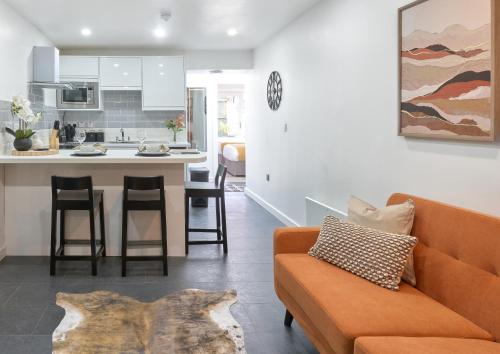 a living room with a couch and a kitchen at The Lush Apartment Cardiff Central 2 Bedrooms in Cardiff