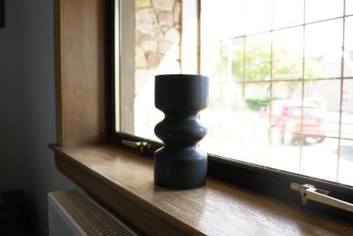 a black candle sitting on a window sill at Sauchie House in Sauchie