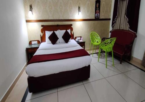 a hotel room with a bed and two chairs at Tea county in Munnar