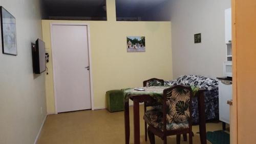 a room with a table and chairs and a door at Smart Flat Rio in Rio de Janeiro