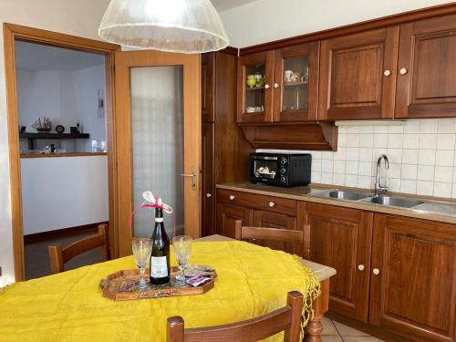 a kitchen with a table with a yellow table cloth on it at Casa vacanze Le due P in Bollengo