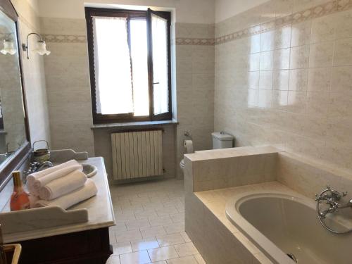 a white bathroom with a tub and a sink at Casa vacanze Le due P in Bollengo