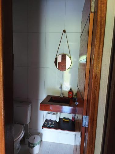 a small bathroom with a sink and a toilet at Chalé Sítio Recanto dos Sonhos in Aimorés