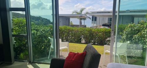 a room with a view of the ocean from a balcony at Villa 3 Luxe Coastal Escape in Cable Bay