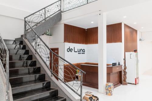 a spiral staircase in a building with a lobby at De Luna Guest House in Kuripan