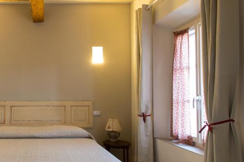 Ein Bett oder Betten in einem Zimmer der Unterkunft Verdenoce Agriturismo
