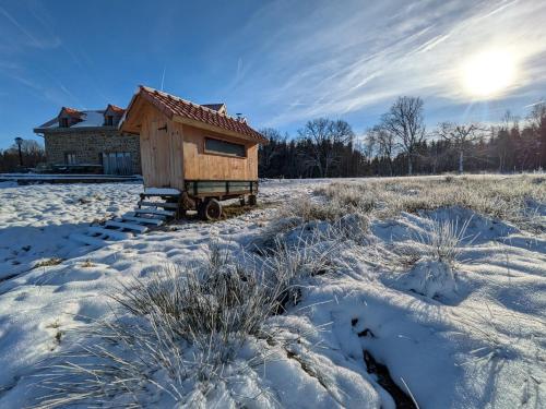a small wooden house in a snow covered field at La Petite Maison dans la Prairie in Pepinster