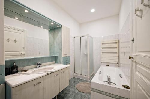 une salle de bain avec deux lavabos et un grand miroir dans l'établissement La Maison d'Annie - A 10min de la place Stanislas, à Nancy