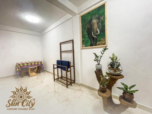 a room with a painting of an elephant on the wall at SunCity Airport Transit Stay in Minuwangoda