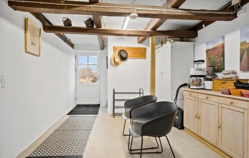 a kitchen with a table and a chair in it at Stunning Apartment In Middelfart in Middelfart