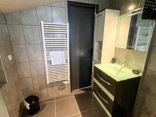 a bathroom with a sink and a mirror at Le Bel Vu - Sea view in Le Barcarès