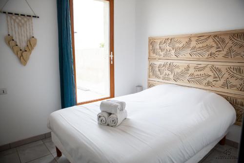 a white bed with a toy truck on top of it at Le Bel Vu - Sea view in Le Barcarès