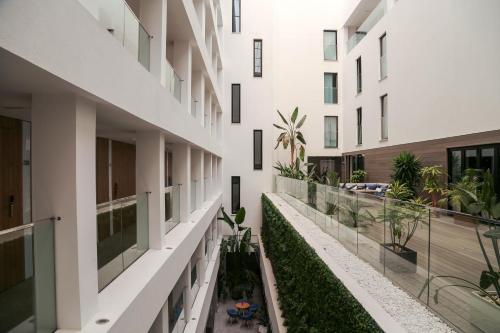 an internal courtyard of a building with plants at Eurostars Puerto de Ibiza in Ibiza Town