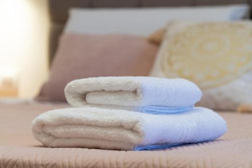 a stack of towels sitting on a bed at VitouHouse Lakones in Lákones