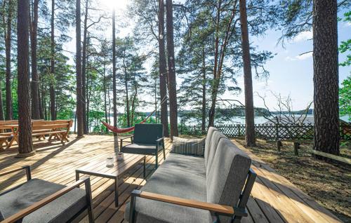 Una terraza de madera con un sofá y sillas. en 2 Bedroom Lovely Home In Borsk, en Borsk