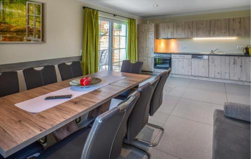 a dining room with a large wooden table and chairs at Nice Home In Mariapfarr With Sauna in Mariapfarr