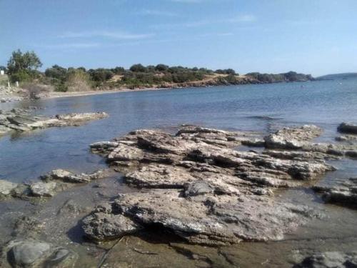 a body of water with rocks in the water at Evia Escape in Diliso