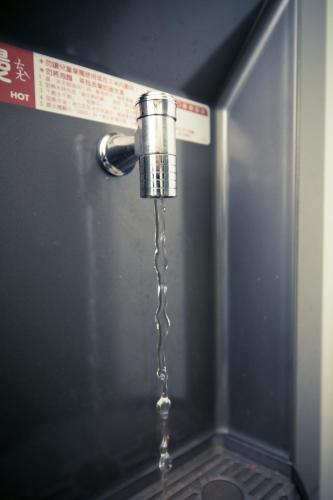 a stream of water coming out of a tap at SleepBox Hostel in Taipei
