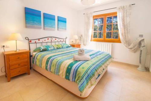 a bedroom with a bed with a towel on it at Villa Calma by Mallorca Infinity in Santa Ponsa