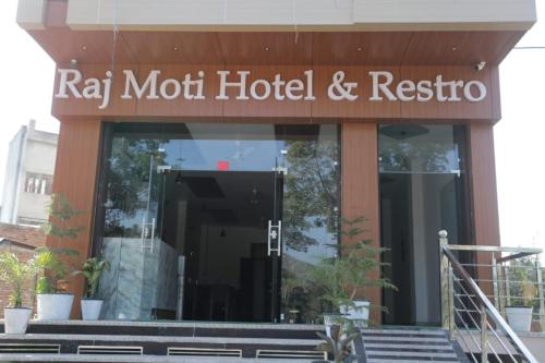 a hotel with a sign that reads ray mott hotel and restore at Rajmoti hotel & Restro in Udaipur