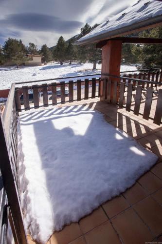 a pile of snow on a porch with a gazebo at Hotel Avet in La Coma i la Pedra