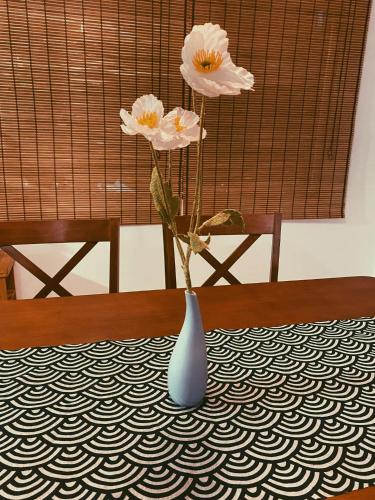 a blue vase with flowers in it on a table at Aimei Bang Saray in Bang Sare