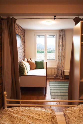 a living room with a couch and a window at einzigartiges stylisches Loft im Grünen in Zell
