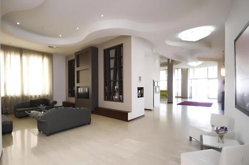 a living room with a couch and a table at Sunrise Hotel in Casoria