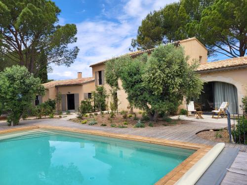 une piscine devant une maison dans l'établissement La Bastide des Amis, à Caromb