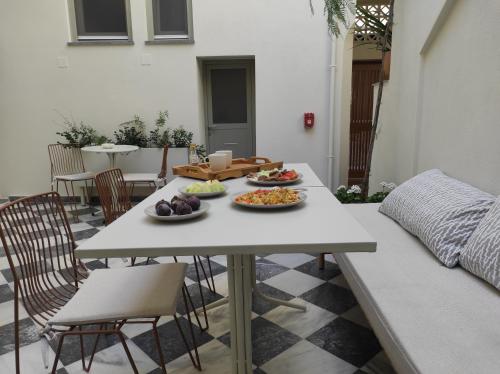 a table with two plates of food on it at enδόtera chios apartments in Chios