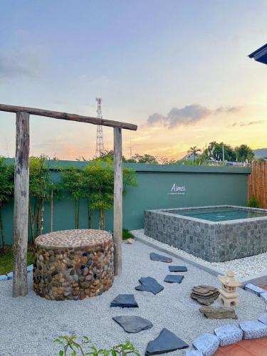 a backyard with a swimming pool and a fire hydrant at Aimei Bang Saray in Bang Sare