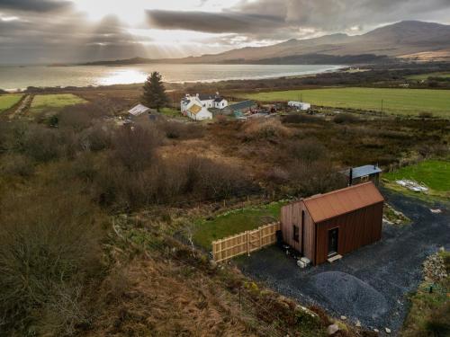an overhead view of a small building in a field at Jura - The Rusty Hut in Craighouse