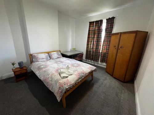 a bedroom with a bed and a dresser at Double-Bedroom in the Heart of Salford Manchester Perfect for Short Stays GCSW3 in Manchester