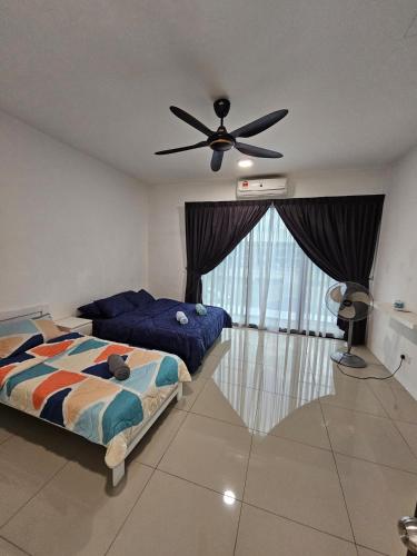 a bedroom with two beds and a ceiling fan at Thea Homestay in Sepang