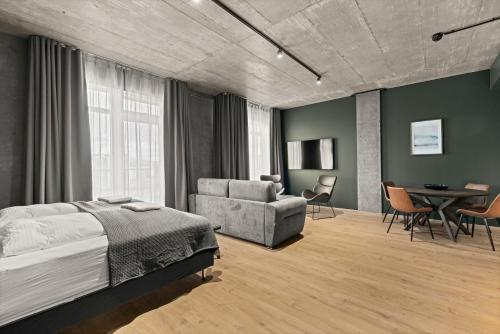 a bedroom with a bed and a couch and a table at Aurora Nooks by Heimaleiga in Reykjavík
