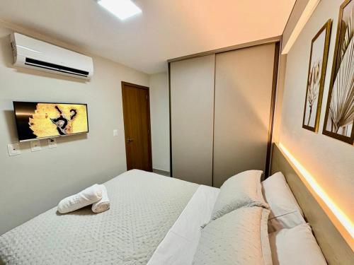 a bedroom with a bed with a headboard at Paradise at your fingertips in Cabedelo