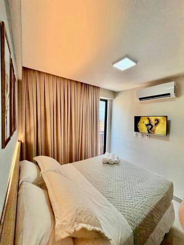 a bedroom with a bed with two pillows on it at Paradise at your fingertips in Cabedelo