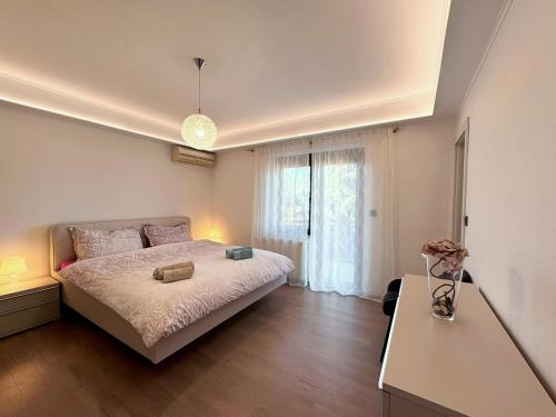 a bedroom with a large bed and a window at Apartments Katarina in Malinska