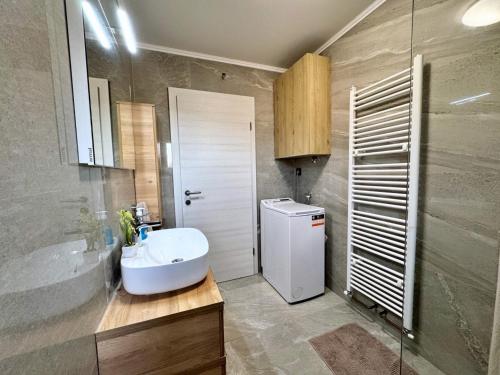a bathroom with a sink and a toilet and a shower at Apartments Katarina in Malinska