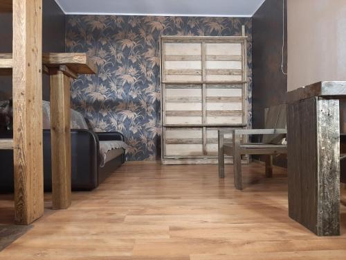 a room with a wooden floor and a dresser at Champêtre Park View Apartments in Rīga
