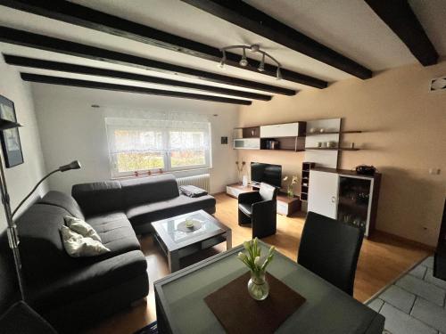 a living room with a couch and a table at Ferienwohnung Gaby - im Weingut Doll in Gleiszellen-Gleishorbach