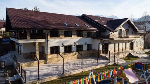 a house with a playground in front of it at Two Rivers Bran in Bran
