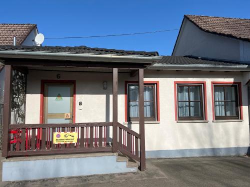 a house with a balcony with a sign on it at Schwarzwaldperle in Zimmern ob Rottweil