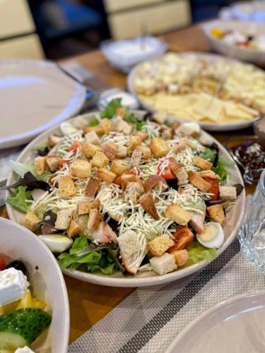 a plate of food with a salad on a table at Sherwood Lake Hotel in Berezovka
