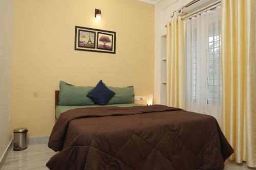 a bedroom with a large bed and a window at AVANTI CASTELLO in Guruvāyūr