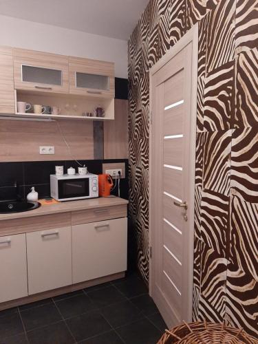 a kitchen with a zebra patterned wall at AVIATRIX Night Airport Haven in Rīga