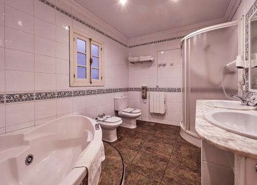 a bathroom with a tub and a toilet and a sink at Don Pedro in Avilés