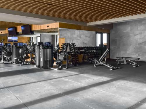 a gym with several rows of exercise bikes and machines at Swissôtel Damian Jasna in Demanovska Dolina